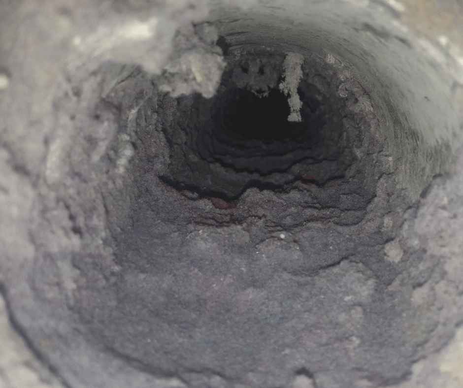 Miller Attics technician inspecting a dryer vent during a free in-home inspection