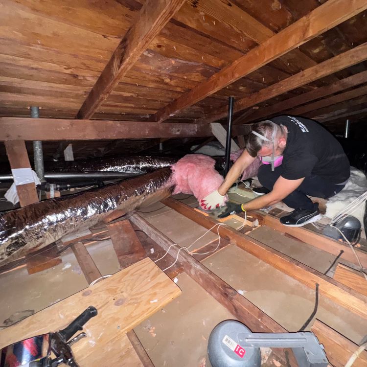 miller attics worker installing attic insulation