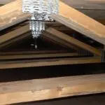 Exposed open web floor trusses in a residential crawl space before insulation