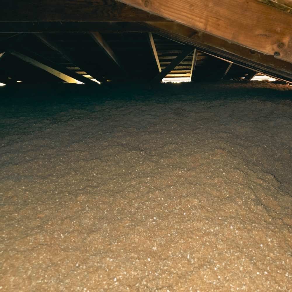 Insulation work inside a real Novato attic — Novato's 70s tract homes and 80s subdivisions often need full-depth cellulose after decades of settling